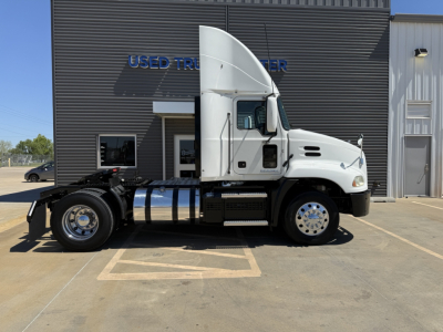 Truck cab and chassis of a 2018 Mack CXU612 daycab showing side profile and fuel tanks.