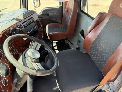 Interior cab of 2018 Mack CXU612 day cab showing steering wheel, dashboard with gauges, and brown/black cloth seats.