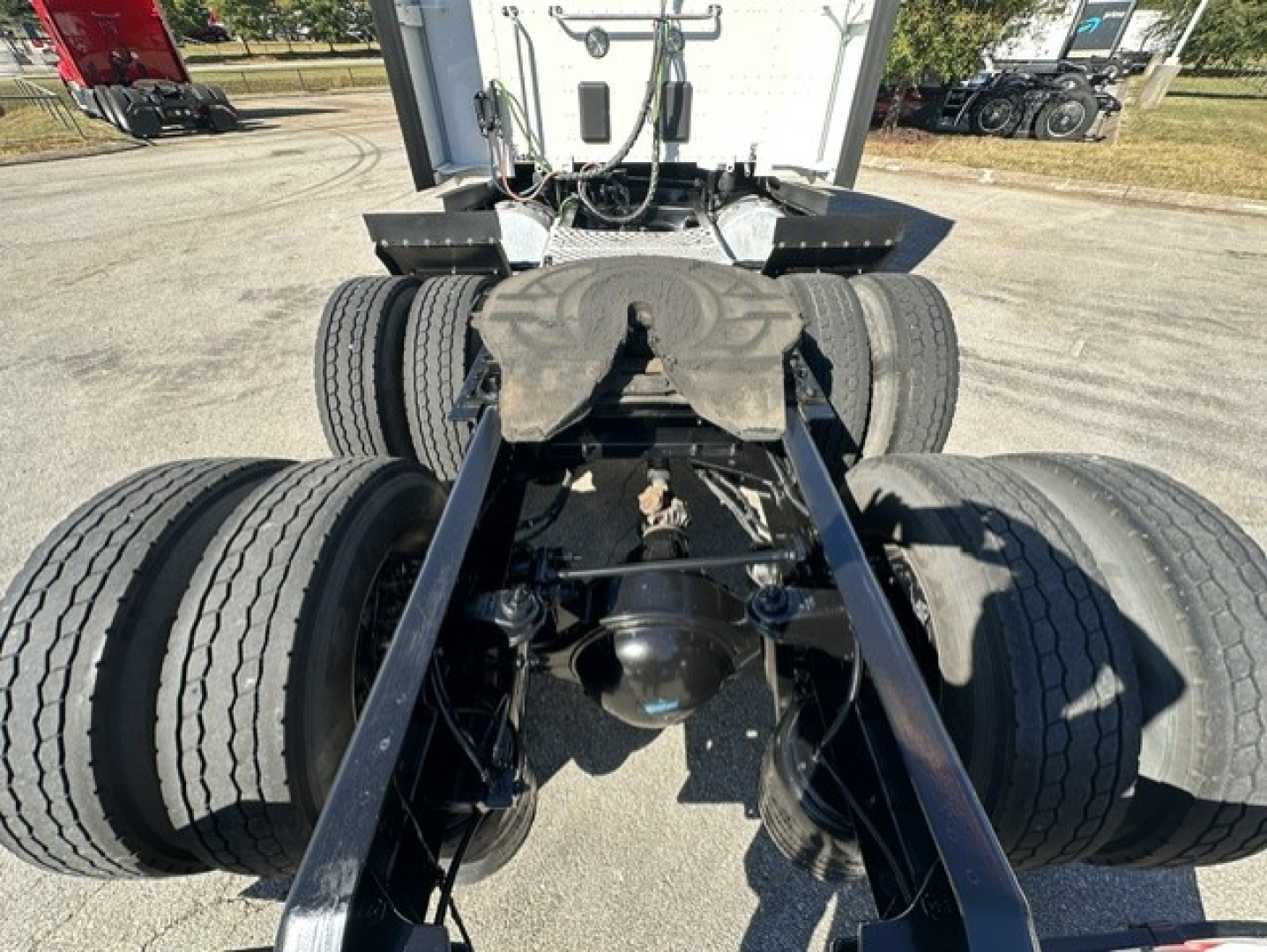 Kenworth T680 chassis view showing rear axle and dual tandem wheels, fifth wheel mounting, and suspension components.