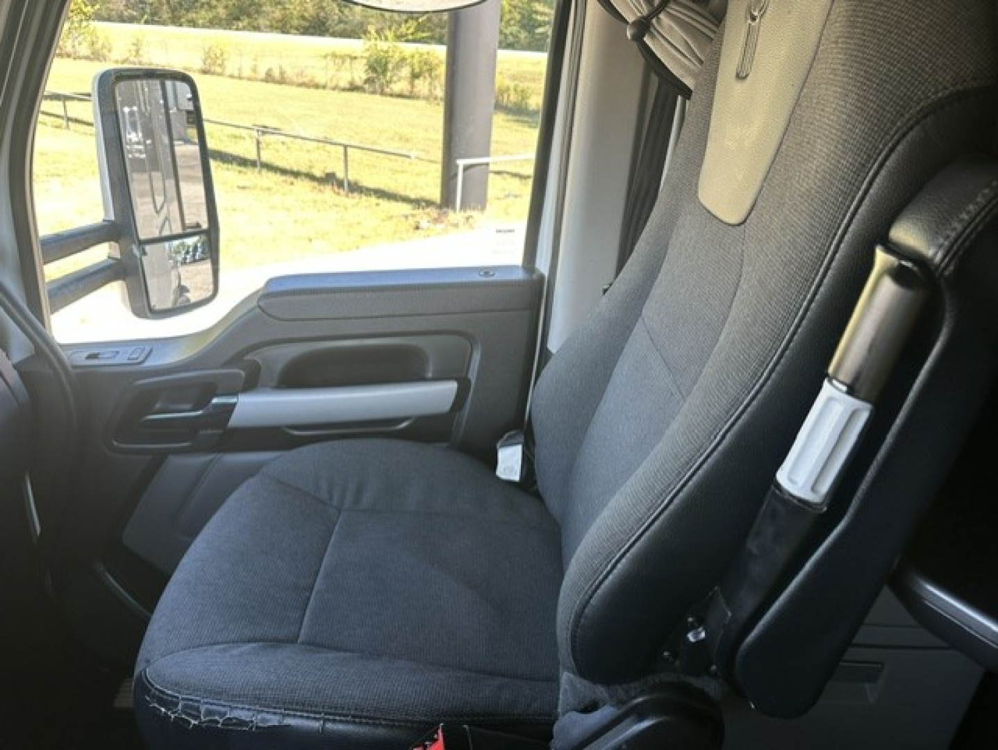 Kenworth T680 truck interior driver seat and door panel view.