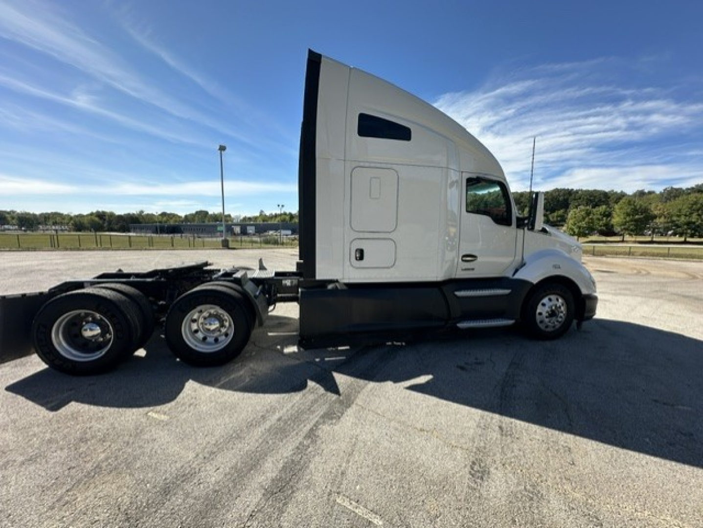 Kenworth T680 truck side profile showing sleeper cab and rear dual axles with wheel tires visible.