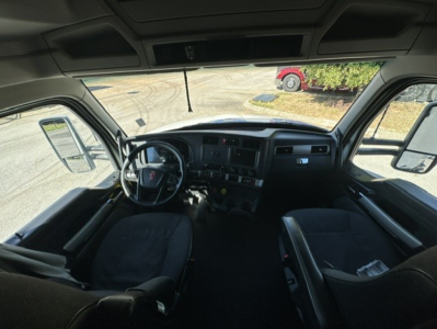 Kenworth T680 truck cab interior view showing dashboard, steering wheel, and seats.