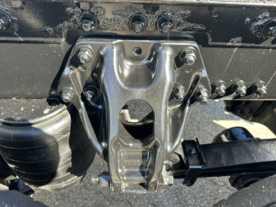 Kenworth T680 rear undercarriage showing fifth wheel hitch and suspension components.