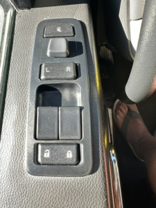 Kenworth T680 interior driver's door panel showing window/lock controls and mirror adjusters.