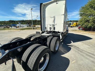 Kenworth T680 tractor rear view showing cab, sleeper, and dual rear axles with fifth wheel and frame rails.