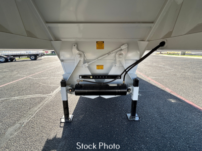 Trailer hitch bottom view showing landing gear and hydraulic line attachments on a CTS BDT40 spring dump trailer side.