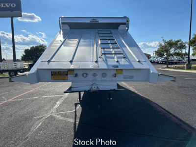 Stock photo of a dump trailer tailgate with ladder and safety decals. Visible labels include ATTENTION signs, various warning icons, and a central hitch area.
