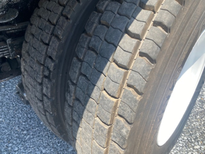 Truck wheel/tire assembly of a 2007 International 7400 dump truck showing dual rear tires with tread pattern.