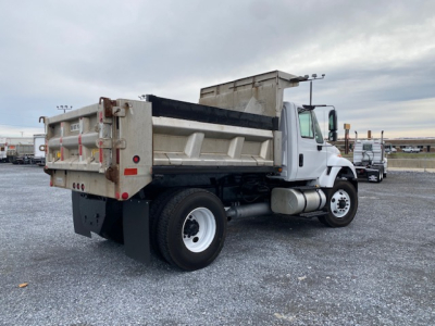 Dump truck bed and cab of a 2007 International 7400 with a dump body and rearview showing side profile.