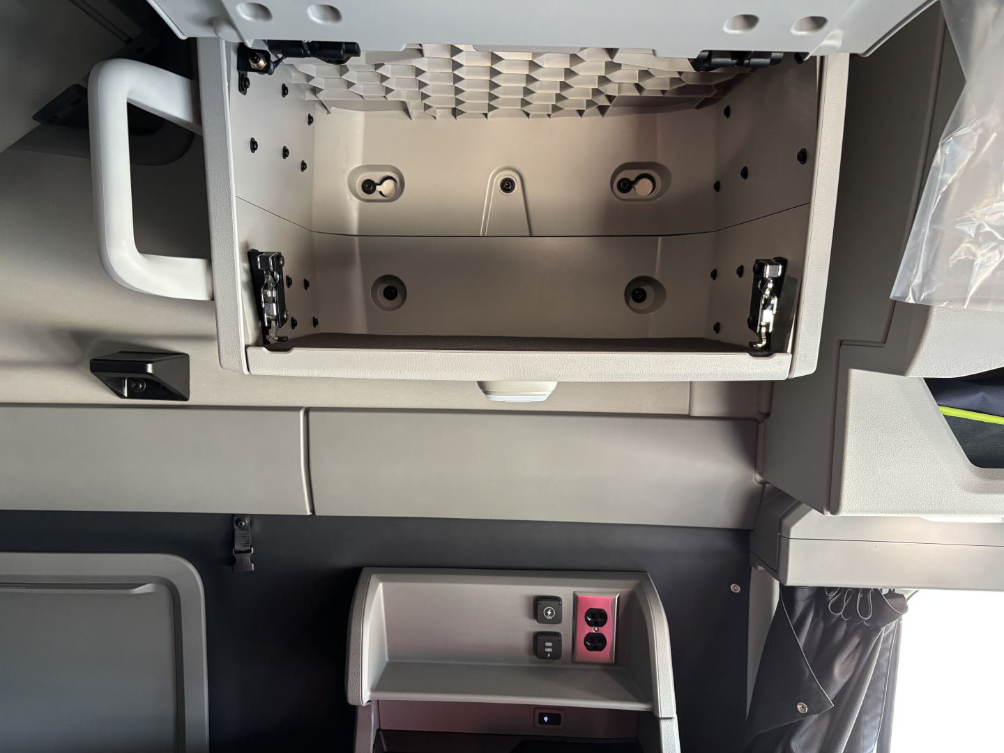 Vehicle interior storage compartment with empty center console and surrounding panels; no legible model text visible in the image.