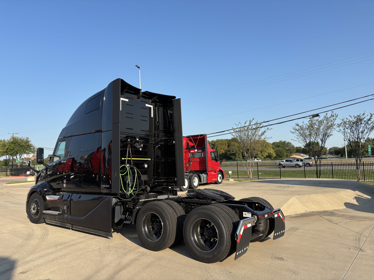 Volvo VNL64T860 truck tractor in sleeper configuration, side view with open rear section showing chassis and fifth wheel area.