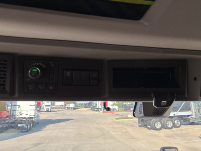 Volvo VNL64T860 cabin interior controls and sun visor area showing dash switches and monitor slot.