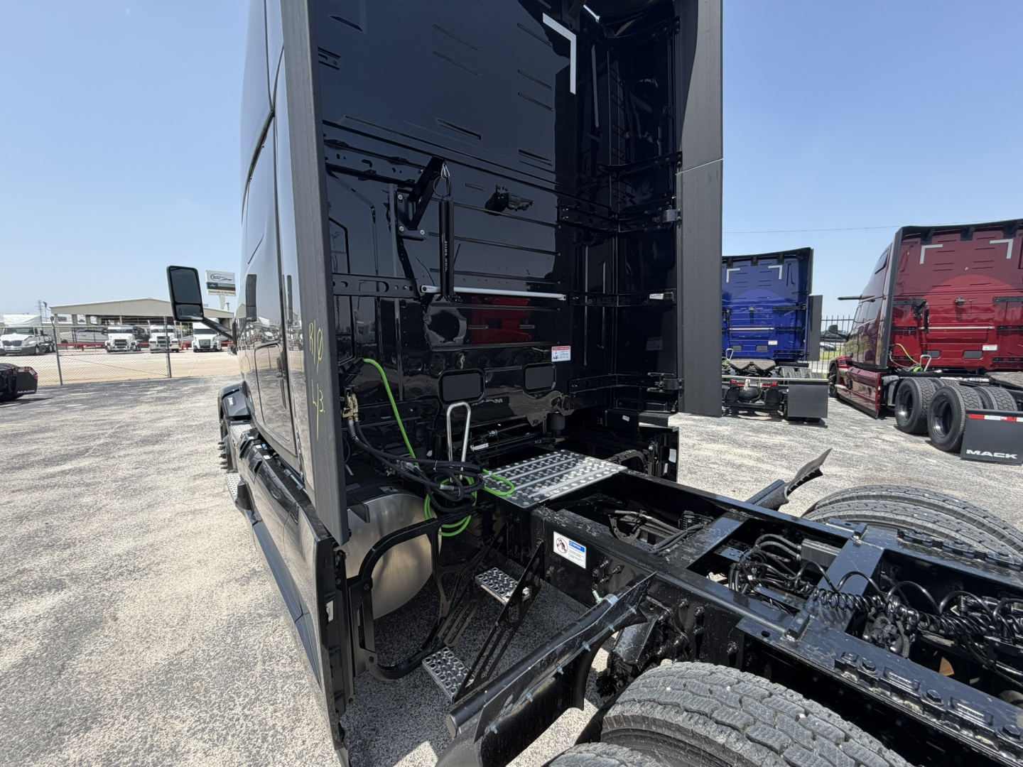 Truck cab rear view showing chassis and fifth wheel area with black painted frame and exposed components.