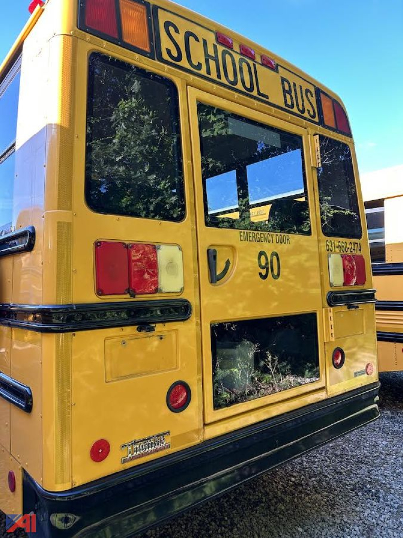 School bus rear view with 'SCHOOL BUS' sign, emergency exit door, and bus number 90 visible.