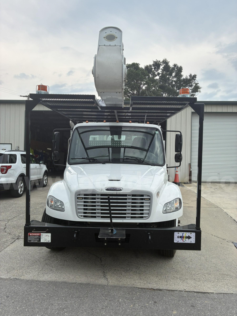 Front view of a 2018 Freightliner M2 106 bucket truck with a raised aerial lift, black front bumper and cage, stock number 534-213.