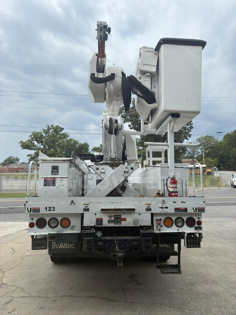 Freightliner M2 106 bucket truck rear view with elevated platform and bucket, utility controls, and rear tires visible.