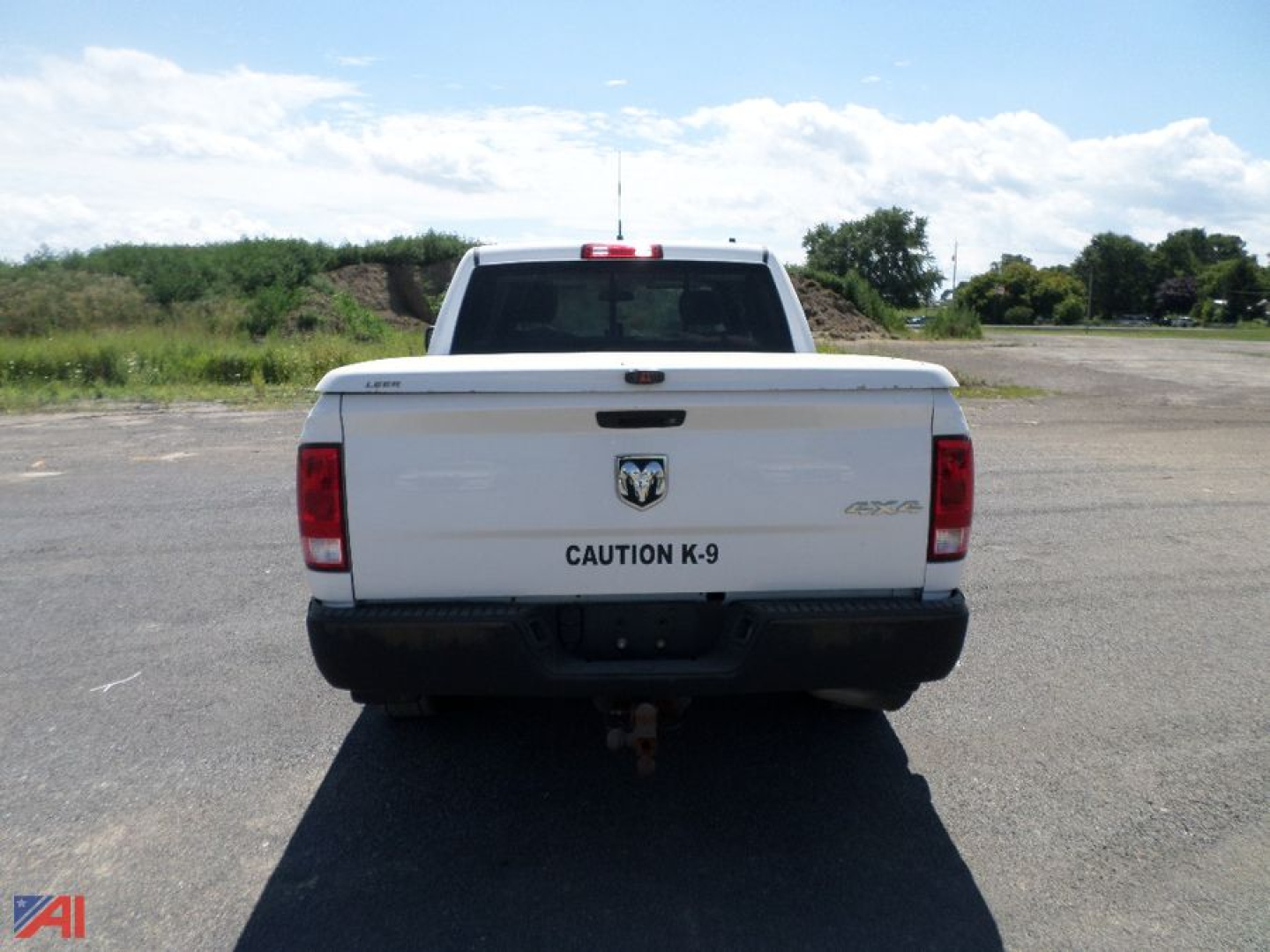 Ram 1500 pickup truck rear view showing CAUTION K-9 badge and RAM emblem