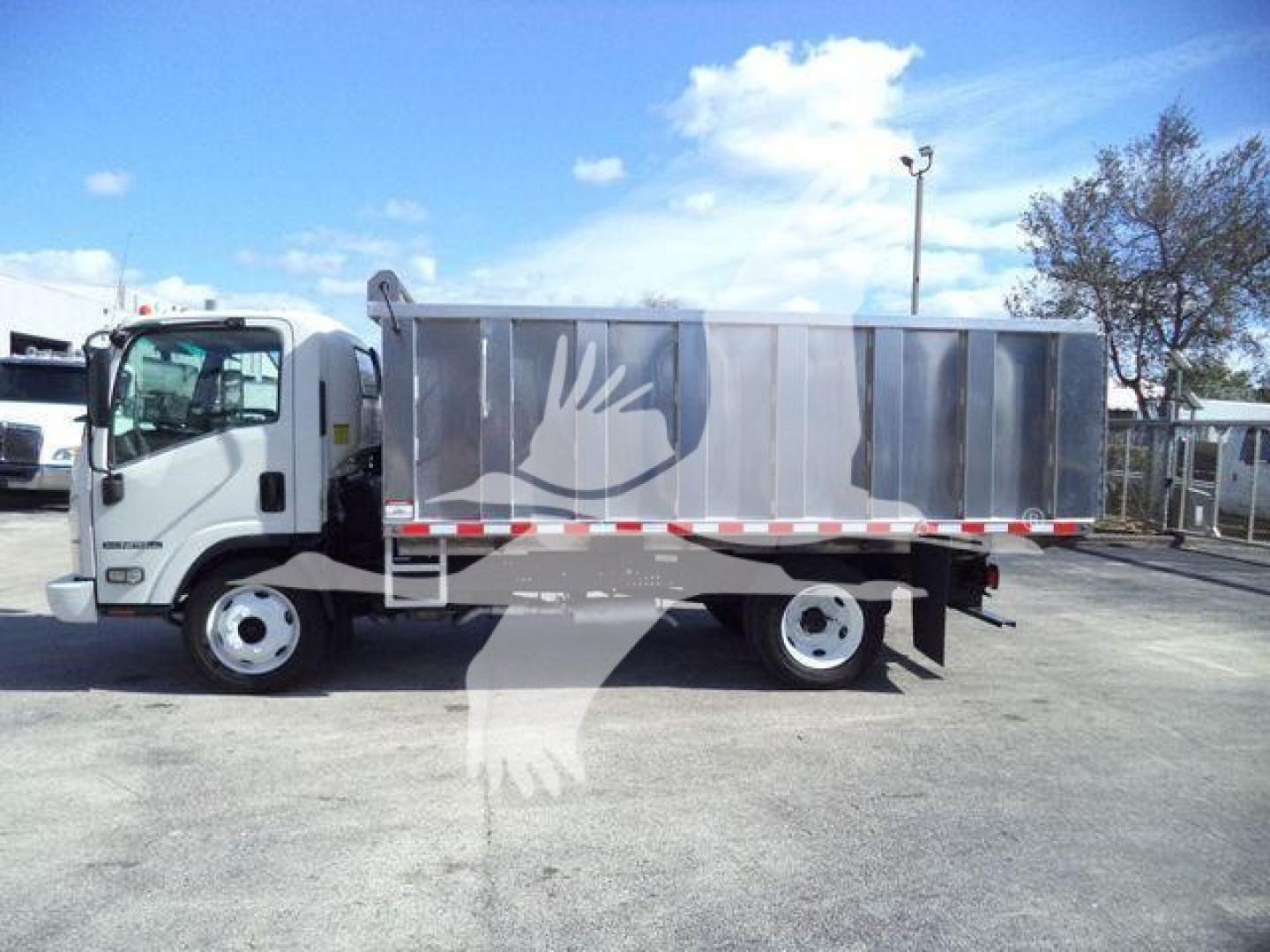 Isuzu NPR-HD truck in landscape orientation showing a dump bed with silver metallic panels and white cab.
