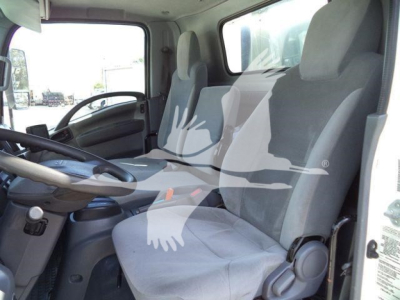 Isuzu NPR-HD truck cab interior showing driver seat and passenger seat, steering wheel, and dashboard view.