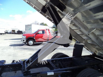 Isuzu NPR HD truck with raised dump bed showing chassis and hydraulic components in the bed area.