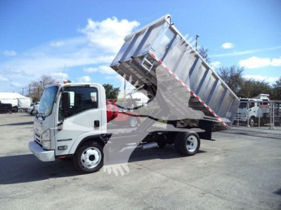 Isuzu NPR HD dump truck in service position with bed raised, side-view showing cab and front wheel, stock number T04505FM.