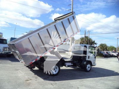Isuzu NPR HD dump truck with bed raised showing rear wheels and cargo bed.