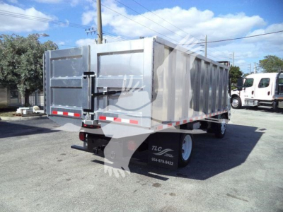 Isuzu NPR HD dump truck, rear/side view showing aluminum dump body, taillights, and dual rear wheels.