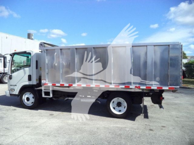 Isuzu NPR-HD dump truck in profile showing side cargo bed and cab, with stock number tag visible in listing.