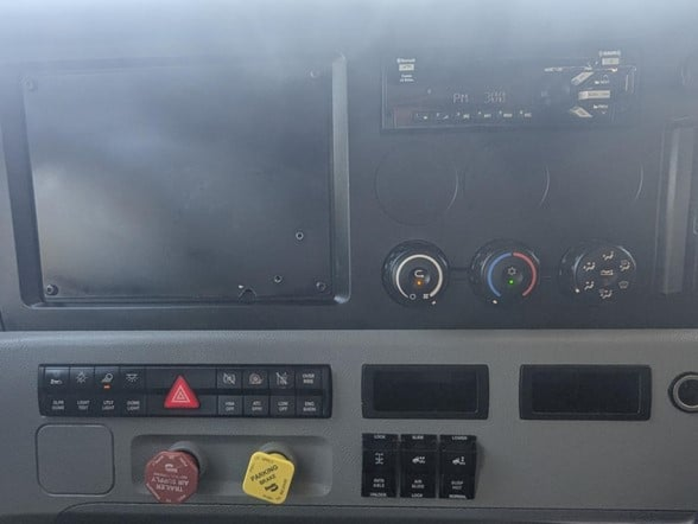 Dashboard of a Freightliner Cascadia 126 truck showing control panel, gauges, and ignition area.