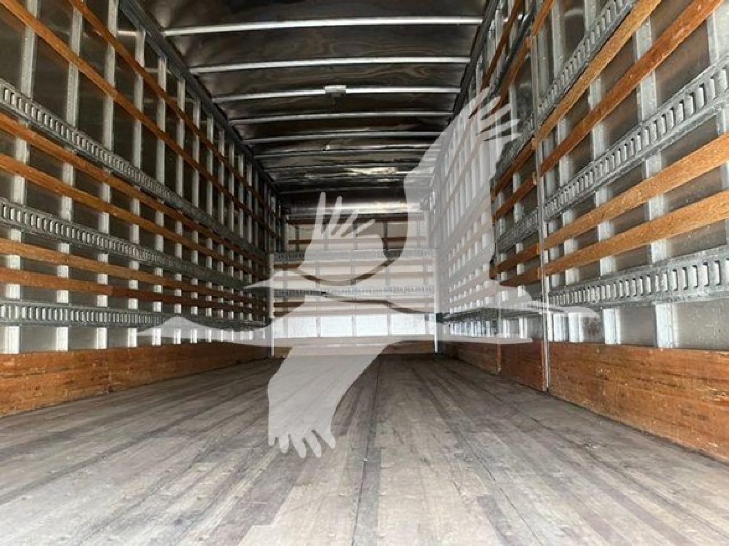 Truck trailer interior empty cargo area with wooden floor and metal side rails, Freightliner M2 106 moving van cargo space.