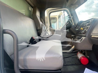 Cab interior of a 2019 Freightliner M2 106 truck showing front seats and dashboard with a fire extinguisher on the floor.