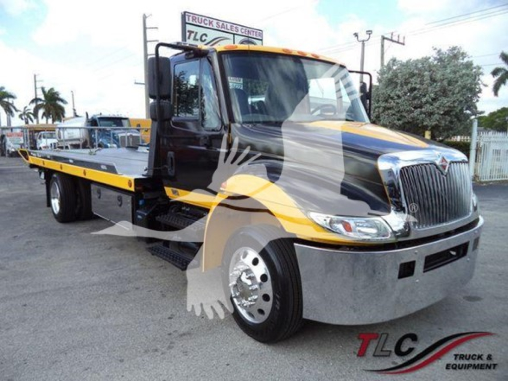International Durastar 4300 rollback truck with black and yellow paint, long flatbed, chrome front bumper, VIN 1HTMMMML0KH382488.