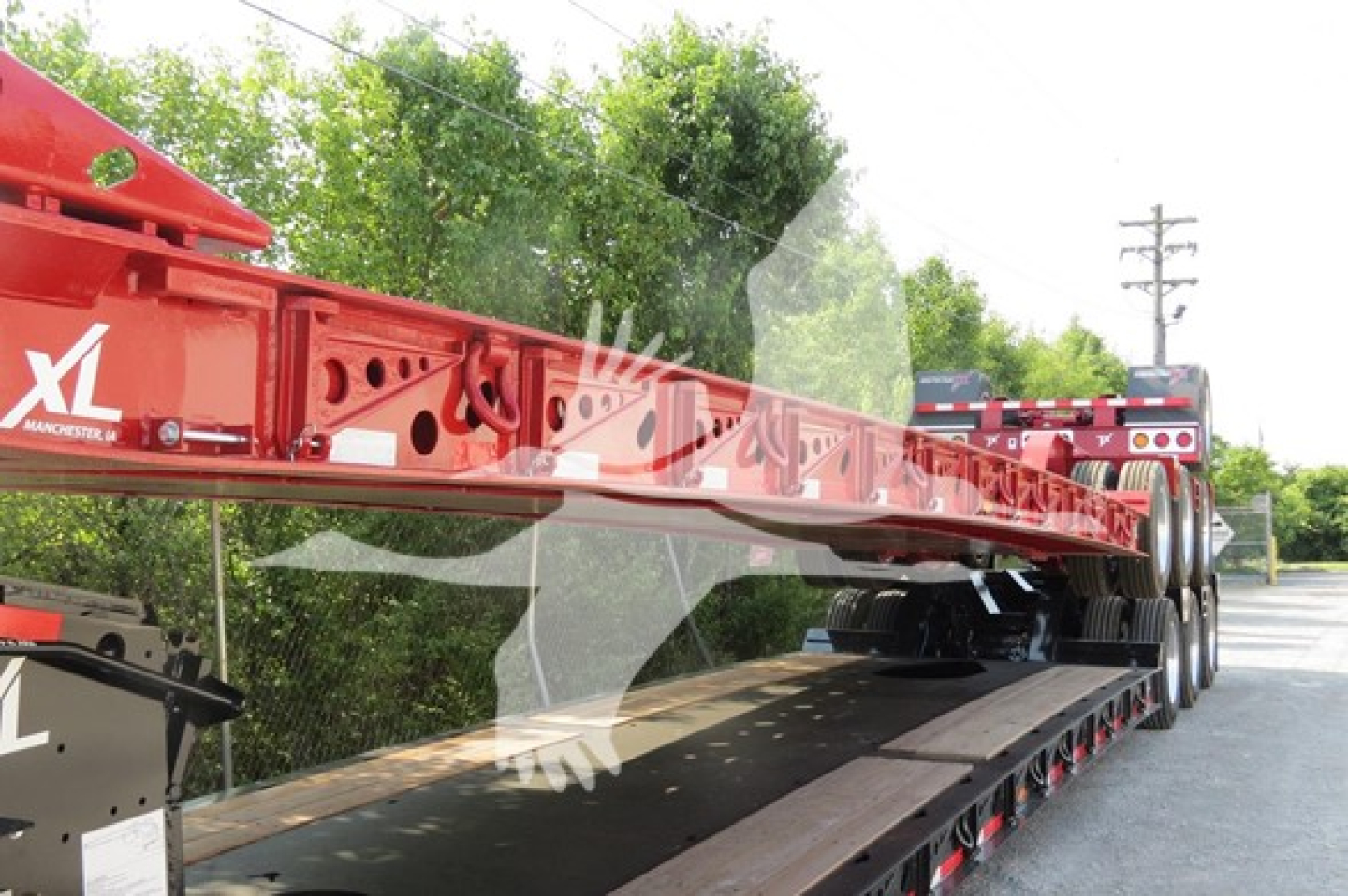 Trailer deck and red XL Specialized 110Hdg-15 lowboy trailer on a flatbed trailer with wheels visible, side lettering 'XL'.