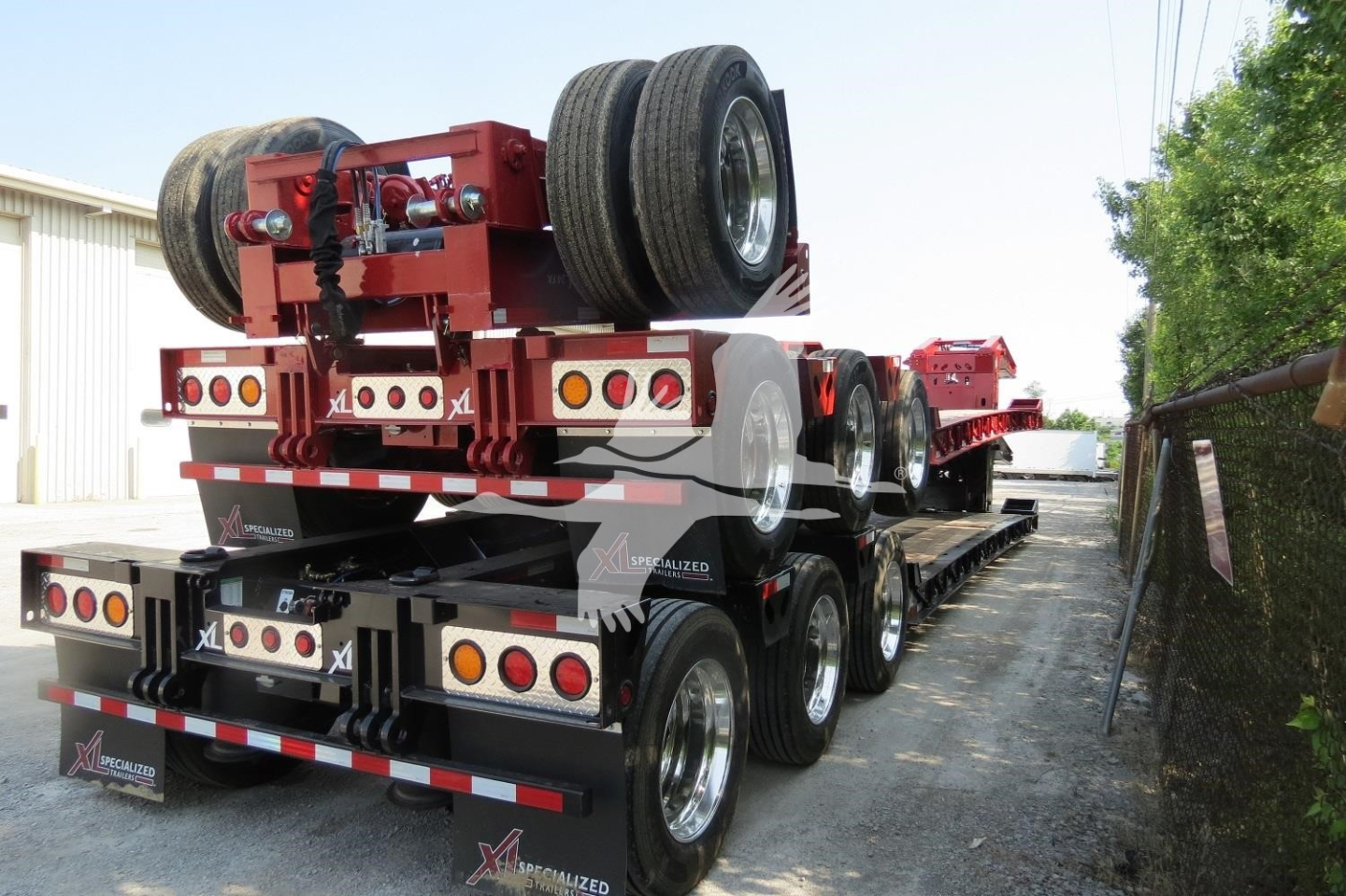 XL Specialized 110Hdg-15 trailer in view showing multiple axles and rear lighting.