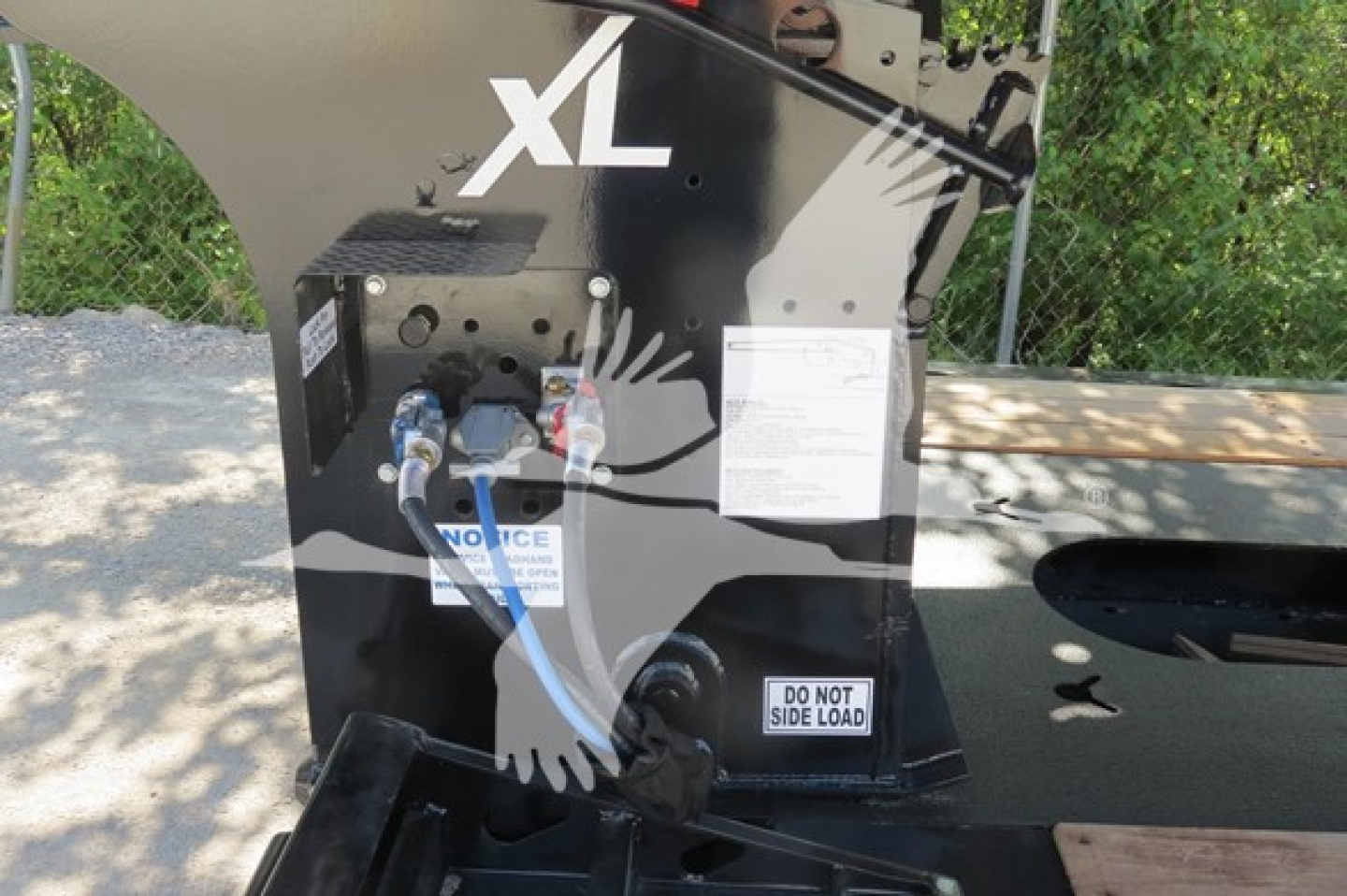 XL Specialized 110Hdg-15 trailer component showing hydraulic connections and warning labels with VIN and stock info spots on the unit.