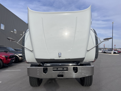 Mack GR64F dump truck front view showing raised hood and chrome bumper