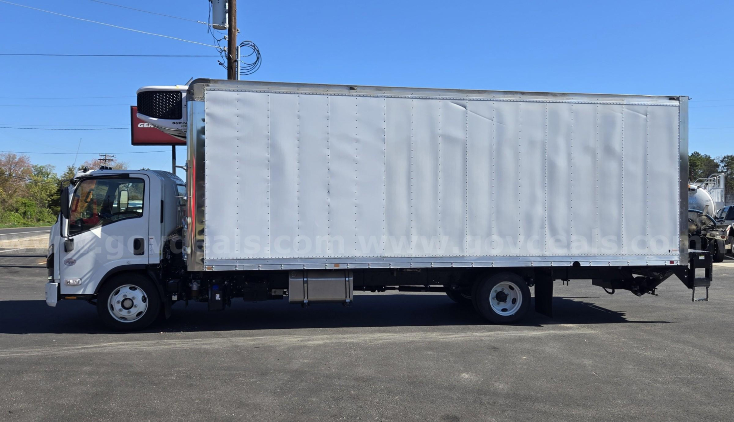 Isuzu NPR truck with a box body, side view showing cargo box and cab in-service light-gray exterior.
