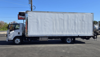 Isuzu NPR truck with a box body, side view showing cargo box and cab in-service light-gray exterior.