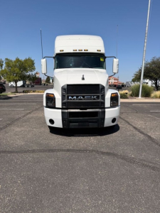 Front view of a white 2020 Mack Anthem truck showing grille with MACK emblem and headlights.