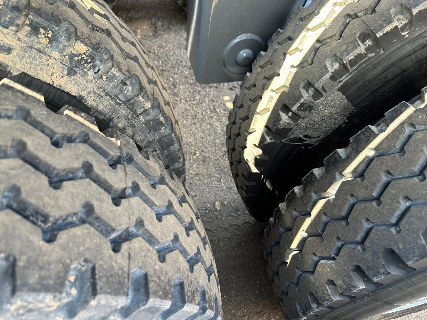 Dump trailer tires close-up view showing dual-tire configuration and tread pattern.