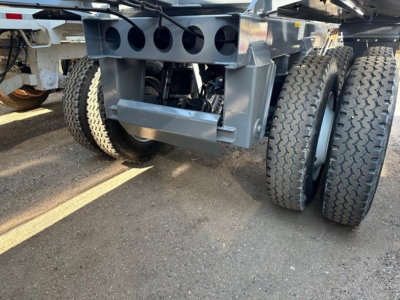 Ranco LW21-40 dump trailer axle area showing dual rear axles and underside framework with grey paint.