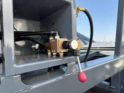 Image of a Ranco LW21-40 valve/actuator mounted inside a gray metal trailer compartment with black hoses and a red-handled lever.