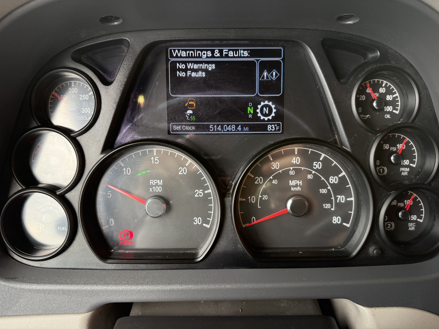 Peterbilt 579 dash cluster and gauge panel showing warning screen, RPM, speedometer, and truck controls.