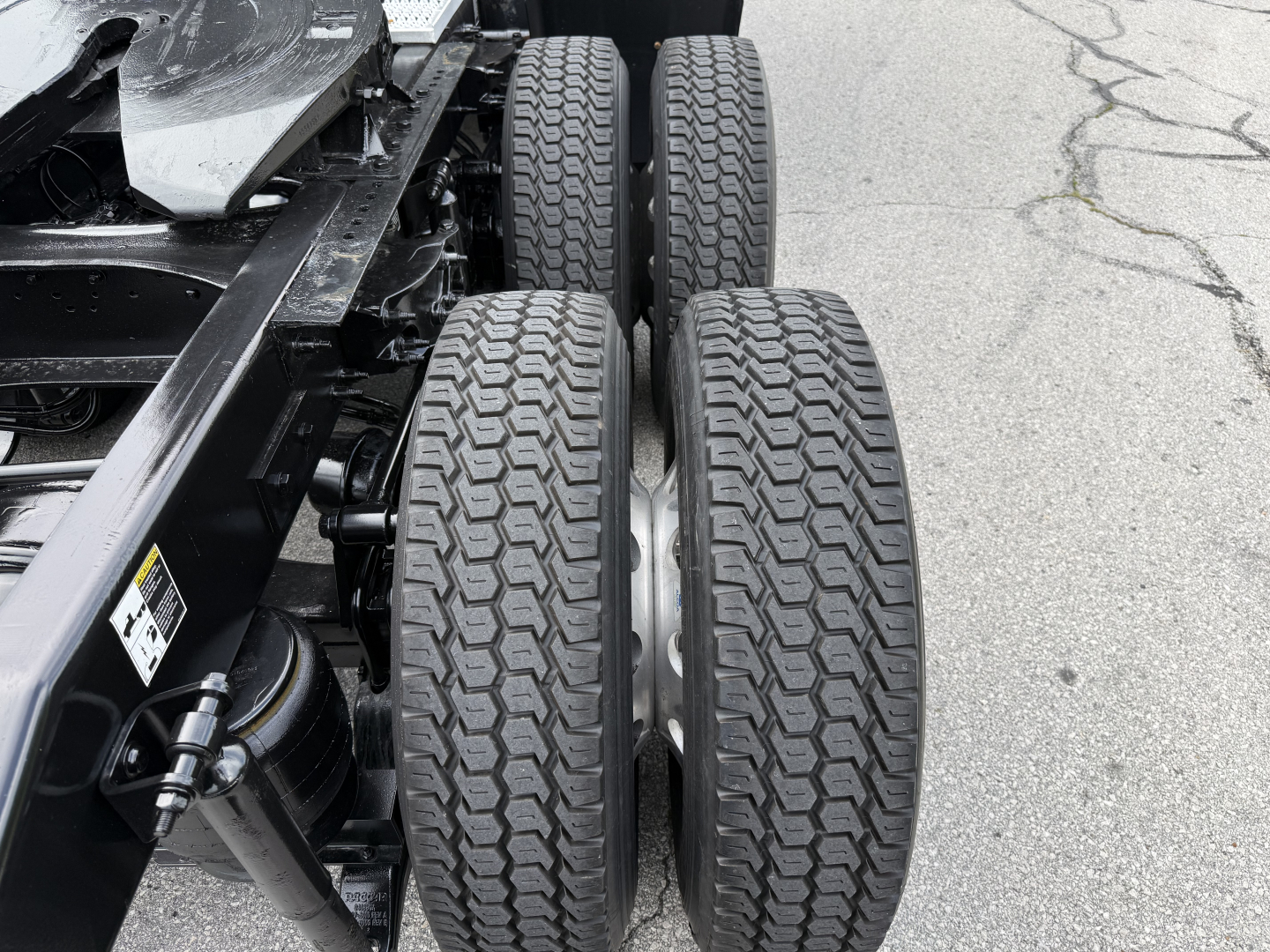 Peterbilt 579 chassis with dual rear axles and tires in view, showing wheel rims and suspension components.