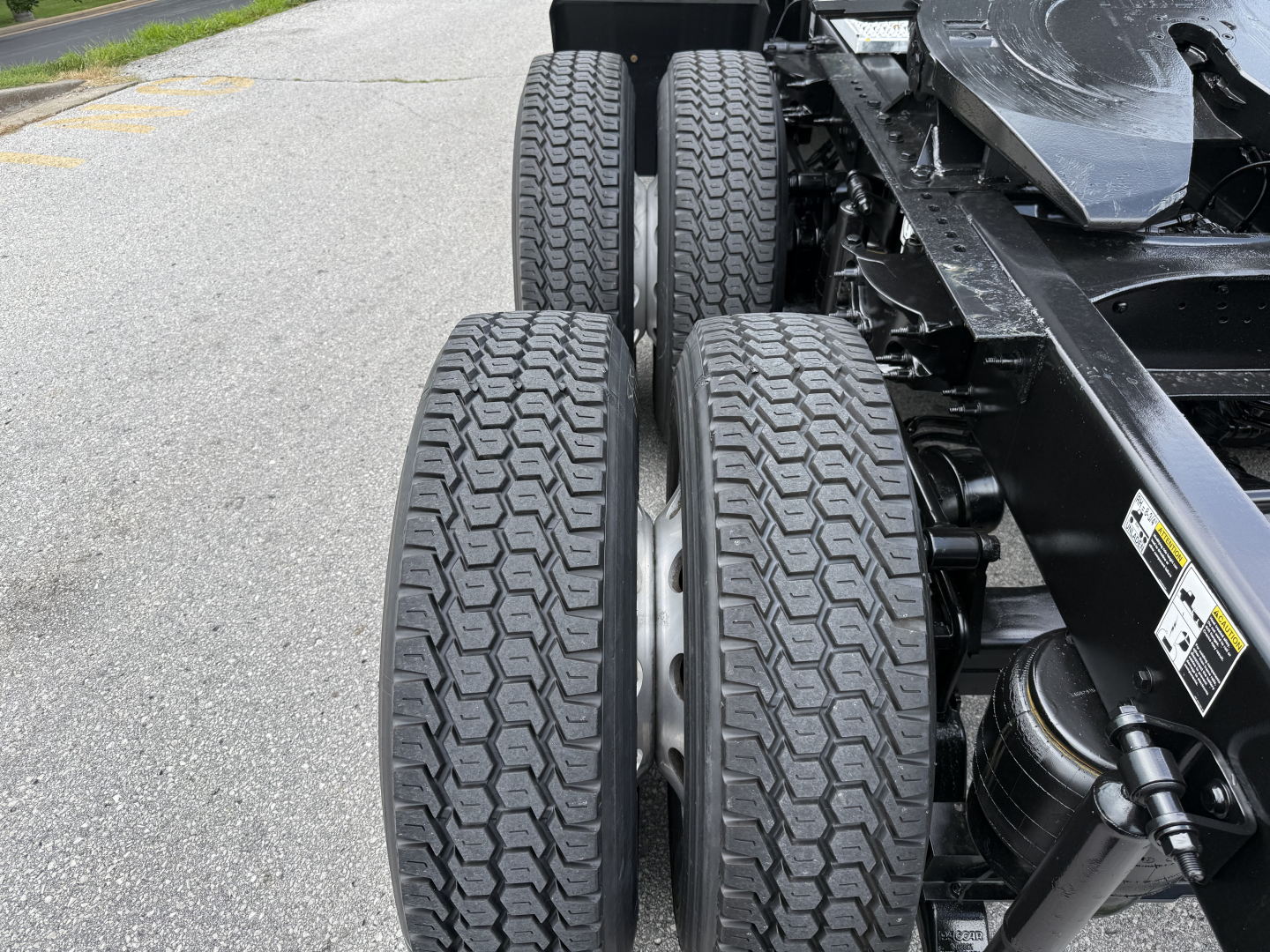 Conventional sleeper truck chassis showing rear dual axle tires and suspension components from a 2022 Peterbilt 579.