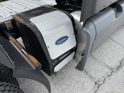 Carrier auxiliary power unit cover and surrounding truck components visible on a 2022 Peterbilt 579 engine bay area.