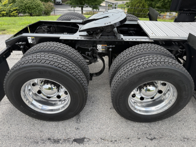 Peterbilt 579 rear dual-axle configuration showing chrome wheels and tire treads with undercarriage components.
