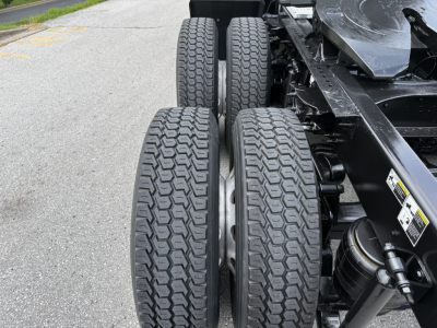 Conventional sleeper truck chassis showing rear dual axle tires and suspension components from a 2022 Peterbilt 579.