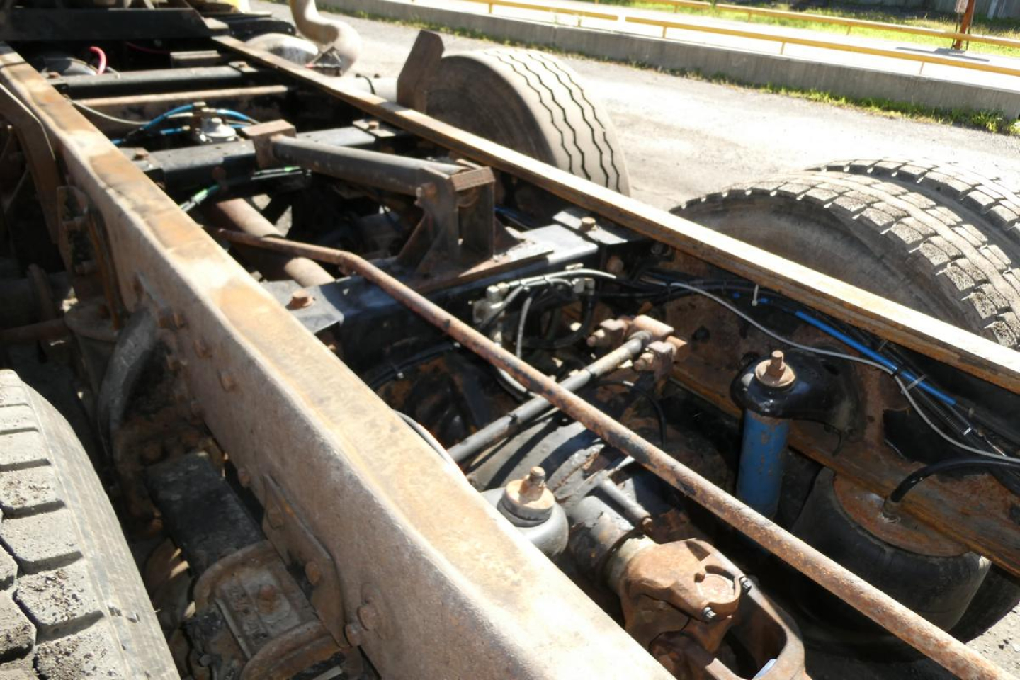Peterbilt 357 chassis showing exposed frame rails, drivetrain, and suspension components with dual rear wheels.