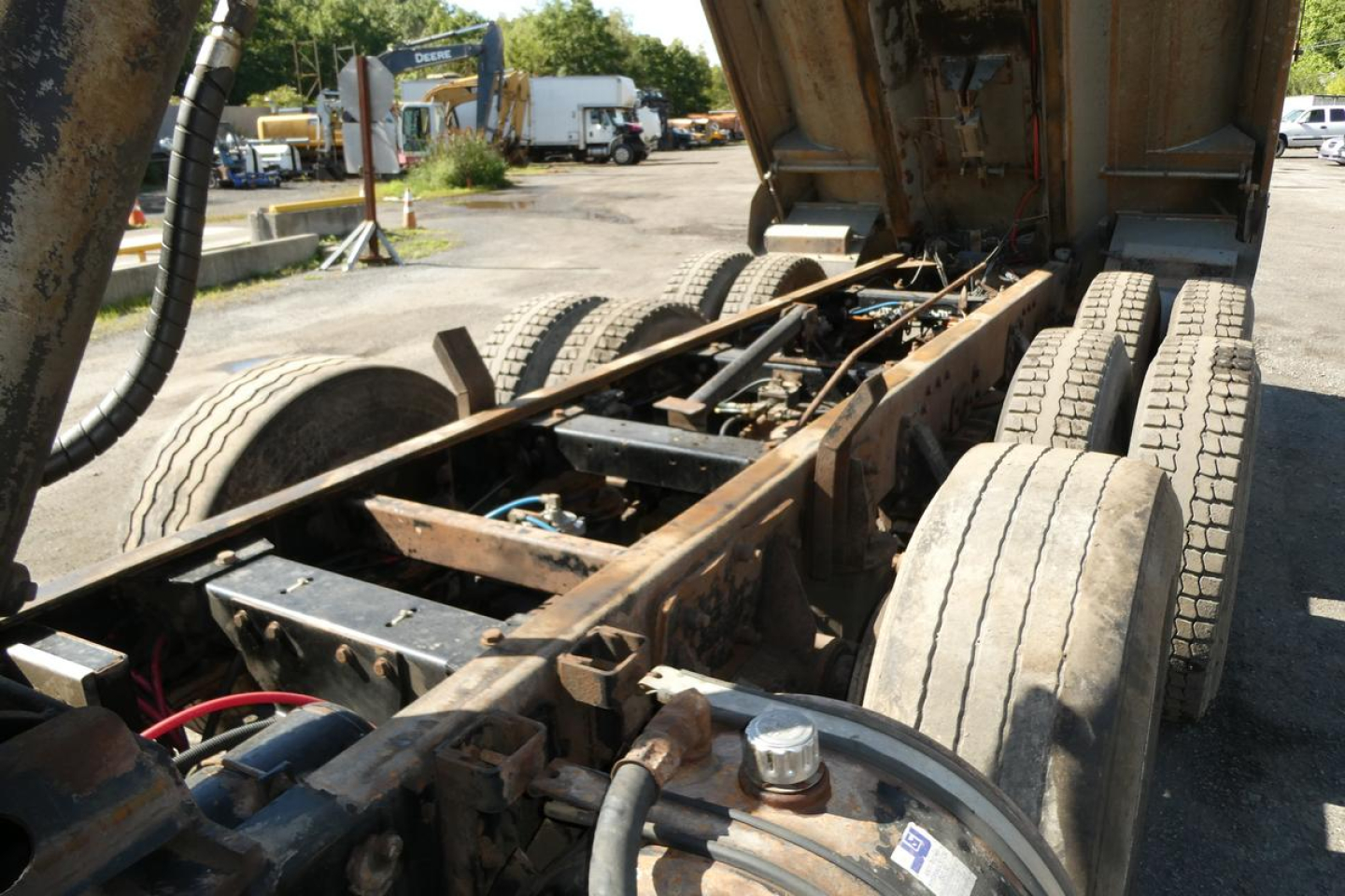Peterbilt 357 truck chassis view showing dump bed in raised position and dual rear axles with tires.